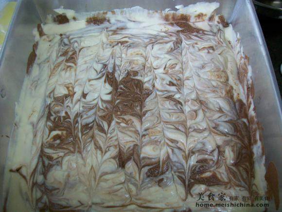 Pouring the chocolate mixture into a baking pan for Making Rich Chocolate and Cheese for the New Year 2011